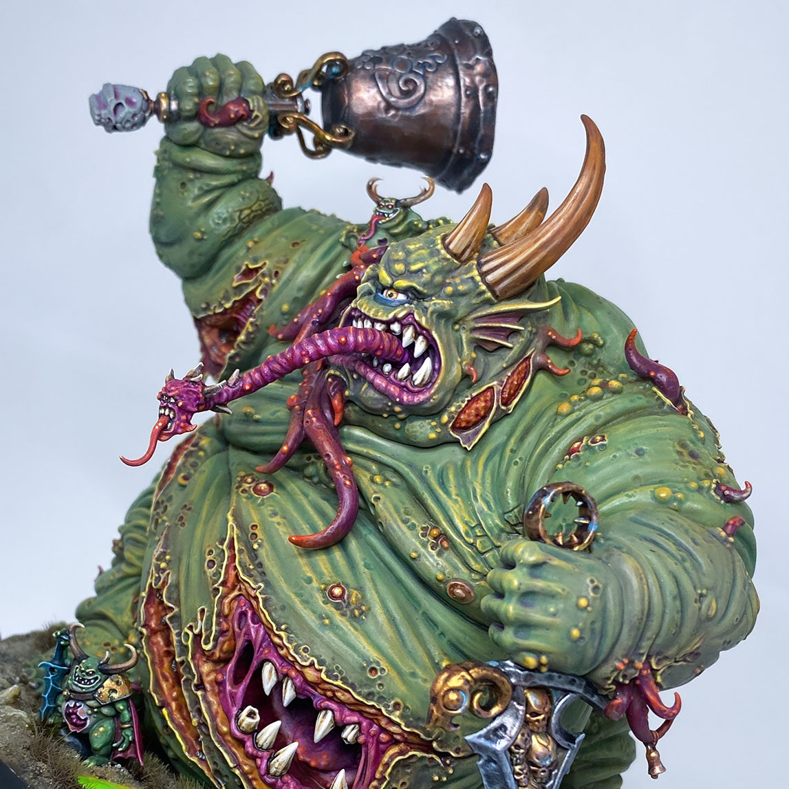 And last but not least…variant #3 of The Great Unclean One is built and painted. There are 3 different distinct builds for AOS and 40K. I have magnetized all the parts of the Great Unclean One and Rotigus. We now have 3 different heads, 3 left arms, 3 right arms and 2 stomach inserts. This way, you can play any variant you want. This is a truly vile model (in the most positive sense of the word!) – it celebrates its corpulence, with rotten, torn flesh slipping aside on its enormous gut to reveal winding intestines within. What an awesome model. Those details are perfectly gruesome. Warhammer - Age of Sigmar and 40K Maggotkin of Nurgle. 👉 Do you want me to build or paint for you? Feel free to contact me. I am excited to hear from you! Height: 13 cm (without weapons) Patching: Green Stuff by citadel_paints Base: custom made with clay Paints: vallejocolors Painted to level: Display Publisher: warhammerofficial Painted by: Debbie Maasdam