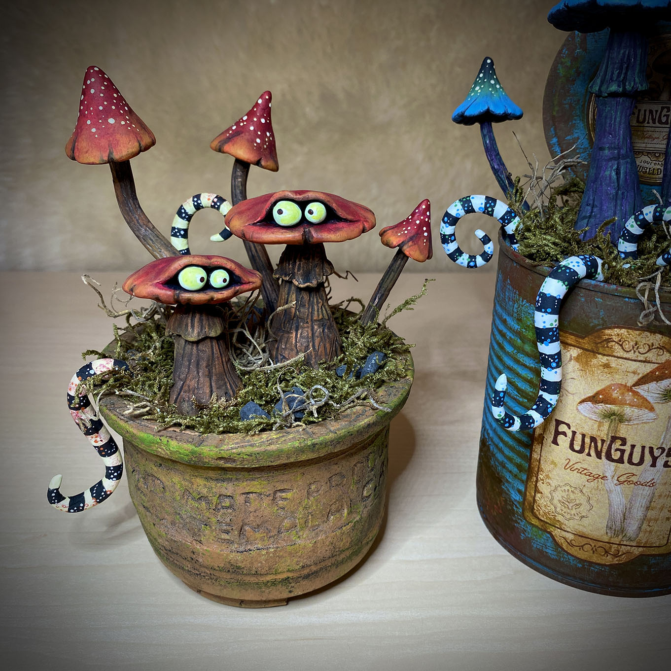 I sculpted and painted these ‘FunGuys’ (funny looking fungi😉). I was inspired by one of my favorite artists, Tim Burton. I sculpted these fellows in air-dry clay. Gave them a pot/can and decorated it with stones and plants. In the realm of whimsical enchantment lies a duo of sculpted miniature toadstools, known as ‘FunGuys,’ whose very name reflects their playful nature. These captivating creations possess an aura of Tim Burtonesque charm. These adorable FunGuys are not mere sculptures; they are portals into a world of imagination and whimsy, beckoning us to embrace the whimsical and find laughter in the ordinary. #funguy #funguys #fungi #fungi_fan_club #funghi #fungiphotography #fungilove #fungifanatic #fungifreaks #fungilover #fungiart #fantasticfungi #guys #funnyguys #toadstool #sculpting #claysculpture #sculpture #sculptures #toad #toads #toadsofinstagram #sculpting #sculpture #sculptureart #mushrooms #mushroom #toadstools #sculpt #timburton #timburtonstyle #timburtonart